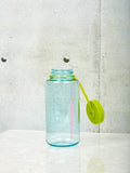 A large seafoam Nalgene by Coming Soon with chartreuse lid and pink Coming Soon logo.