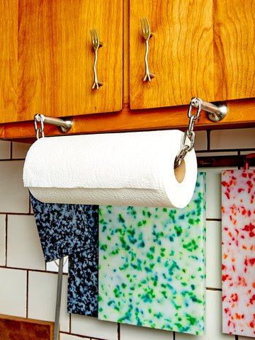 Catena Paper Towel Holder mounted onto wooden cabinetry. 