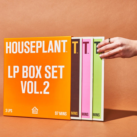 A hand reached for a green vinyl sleeve from the Houseplant LP Box Set Vol 2.