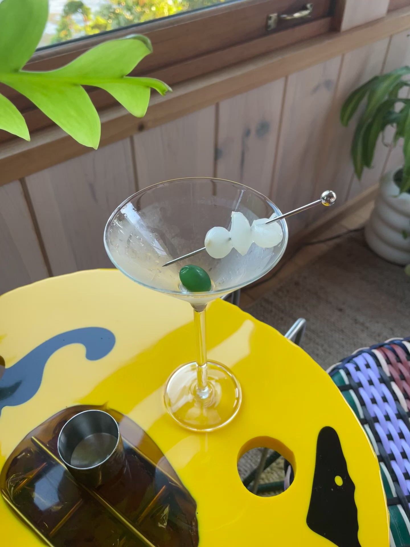 Someone pours a martini from a shaker into the Maison Balzac Martini Glass.